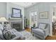 Comfortable living room with a cozy fireplace, light blue armchairs, and serene decor at 17 Trumbo St, Charleston, SC 29401