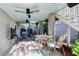 Covered patio for outdoor living with a grill, dining area, and fan for comfort at 17 Trumbo St, Charleston, SC 29401