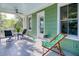 Back porch featuring a sitting area with a fan, green exterior, and a view of nature at 17 Trumbo St, Charleston, SC 29401