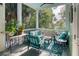 Charming screened porch with seating, plants, and views of the lush surroundings at 17 Trumbo St, Charleston, SC 29401