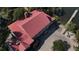 Aerial view of a waterfront home featuring a distinctive red roof, private dock and manicured grounds at 186 N Shelmore Blvd, Mount Pleasant, SC 29464