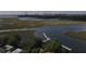 Aerial view of waterfront property with a private dock and scenic marshland, ideal for boating and enjoying nature at 186 N Shelmore Blvd, Mount Pleasant, SC 29464
