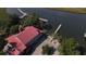 Aerial view of waterfront property with multiple docks, a patio area and a lushly landscaped yard at 186 N Shelmore Blvd, Mount Pleasant, SC 29464