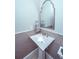 Bathroom featuring a pedestal sink, framed mirror, and grey tiled wall at 186 N Shelmore Blvd, Mount Pleasant, SC 29464