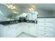 Bathroom boasts double sinks with dark countertops and vanity with white cabinets at 186 N Shelmore Blvd, Mount Pleasant, SC 29464