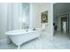 Elegant bathroom features a freestanding soaking tub, marble floors, and a large window at 186 N Shelmore Blvd, Mount Pleasant, SC 29464