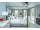 Stylish bedroom with a four-poster bed, plush bedding, and bright windows at 186 N Shelmore Blvd, Mount Pleasant, SC 29464