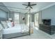 Stylish bedroom with a four-poster bed, plush bedding, and bright windows at 186 N Shelmore Blvd, Mount Pleasant, SC 29464