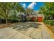Spacious driveway leading to a garage with carriage doors, surrounded by mature trees at 186 N Shelmore Blvd, Mount Pleasant, SC 29464