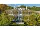 Stately two-story home with double porches surrounded by lush greenery at 186 N Shelmore Blvd, Mount Pleasant, SC 29464
