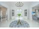 Elegant foyer with a chandelier, round table with flowers, and doorways to adjacent rooms at 186 N Shelmore Blvd, Mount Pleasant, SC 29464