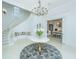 Grand foyer boasts a spiral staircase, chandelier, and entry to the kitchen at 186 N Shelmore Blvd, Mount Pleasant, SC 29464