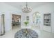 Elegant foyer featuring a chandelier, round table with flowers, and entryways to the kitchen and front door at 186 N Shelmore Blvd, Mount Pleasant, SC 29464