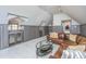 Attic living room showcasing a wet bar, built-in cabinets, and a comfortable seating arrangement at 186 N Shelmore Blvd, Mount Pleasant, SC 29464