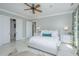 Serene bedroom with an inviting bed, ceiling fan, and an ensuite bathroom at 186 N Shelmore Blvd, Mount Pleasant, SC 29464