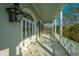 Charming porch with white columns, arched doorway, and views of the lush landscape at 186 N Shelmore Blvd, Mount Pleasant, SC 29464