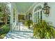 Elegant porch with large columns, potted ferns, and decorative lanterns at 186 N Shelmore Blvd, Mount Pleasant, SC 29464
