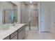 Modern bathroom featuring a glass-enclosed shower with tile surround, double vanity, and sleek fixtures at 200 Belfort Place, Summerville, SC 29486
