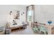 Stylish bedroom featuring a single bed, unique wall decor, a writing desk, and ample natural light at 200 Belfort Place, Summerville, SC 29486