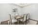 Elegant dining room with a modern chandelier, decorative mirror, and a dining table set for a meal at 200 Belfort Place, Summerville, SC 29486