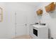 Functional laundry room with white washer and dryer, wire shelving, and storage baskets for efficient organization at 200 Belfort Place, Summerville, SC 29486