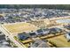 An aerial view that focuses on the residence; a two-story, white home in a Gathering-friendly community at 208 Evergreen Ave, Summerville, SC 29485