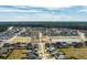 Aerial view of a neighborhood with houses, streets, a pond, and green spaces at 208 Evergreen Ave, Summerville, SC 29485