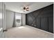 Stylish bedroom featuring a dark accent wall, a ceiling fan, and a large window with natural light at 208 Evergreen Ave, Summerville, SC 29485