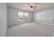 Spacious bedroom with plush carpeting, a ceiling fan, and sunlit windows offering a bright and airy feel at 208 Evergreen Ave, Summerville, SC 29485