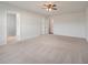 A large, carpeted bedroom with lots of natural light, and doors leading to additional rooms at 208 Evergreen Ave, Summerville, SC 29485