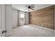 Cozy bedroom featuring a wooden accent wall, a ceiling fan, and a sunlit window with natural light at 208 Evergreen Ave, Summerville, SC 29485
