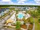The community pool with palm trees, lounge chairs, and a clubhouse offers residents recreation and relaxation at 208 Evergreen Ave, Summerville, SC 29485
