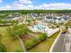 Aerial view of a community pool, playground, and many homes in the neighborhood at 208 Evergreen Ave, Summerville, SC 29485