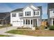Charming two-story home with a covered front porch and a two-car garage at 208 Evergreen Ave, Summerville, SC 29485