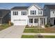 Charming two-story home features white siding, black shutters, and a welcoming front porch at 208 Evergreen Ave, Summerville, SC 29485