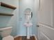 Cozy half bathroom with pedestal sink, floating shelves, and light blue walls at 208 Evergreen Ave, Summerville, SC 29485