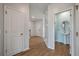 Bright hallway featuring wood floors and an adjacent powder room with pedestal sink at 208 Evergreen Ave, Summerville, SC 29485