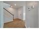 Hallway featuring hardwood floors, staircase with modern railing, and neutral paint at 208 Evergreen Ave, Summerville, SC 29485