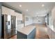 Bright kitchen with stainless steel appliances, central island, and hardwood floors at 208 Evergreen Ave, Summerville, SC 29485