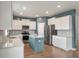 Bright kitchen featuring an island, stainless appliances, white cabinetry, and stylish backsplash and wall paint at 208 Evergreen Ave, Summerville, SC 29485