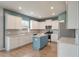 Modern kitchen featuring white cabinets, a blue island, and stainless steel appliances at 208 Evergreen Ave, Summerville, SC 29485
