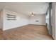 Spacious living room featuring hardwood floors, a ceiling fan, and three floating shelves on the wall at 208 Evergreen Ave, Summerville, SC 29485