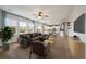 Spacious living room with hardwood floors, ceiling fan, and a view of the kitchen at 208 Evergreen Ave, Summerville, SC 29485
