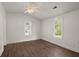Spacious bedroom featuring hardwood floors, two large windows, and a ceiling fan at 209 E 1St N St, Summerville, SC 29483