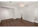 Bright bedroom featuring wood-look flooring, a ceiling fan, neutral walls, and walk-in closet at 209 E 1St N St, Summerville, SC 29483
