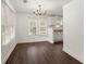 Bright dining room featuring hardwood floors, neutral walls, a modern chandelier, and natural light at 209 E 1St N St, Summerville, SC 29483
