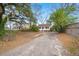Charming home featuring a long gravel driveway and an inviting front porch at 209 E 1St N St, Summerville, SC 29483