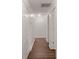 Hallway featuring a series of white doors and hardwood floors at 209 E 1St N St, Summerville, SC 29483