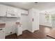 View of the kitchen showing microwave, white cabinets, hardwood floors, and view to the living room at 209 E 1St N St, Summerville, SC 29483