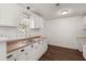 Bright kitchen with white cabinets, stainless steel sink, and lots of natural light at 209 E 1St N St, Summerville, SC 29483